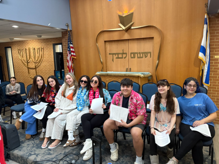 Juniors dressed up for Beach Day as part of their "Juniority Week" celebration.  (L to R on the bema) Naomi Allen, Tali Herbert, Kayla Brach, Alma Adiel, Mia Eskin, Eli Kutten, Rachel Hyman, Leo Milch.