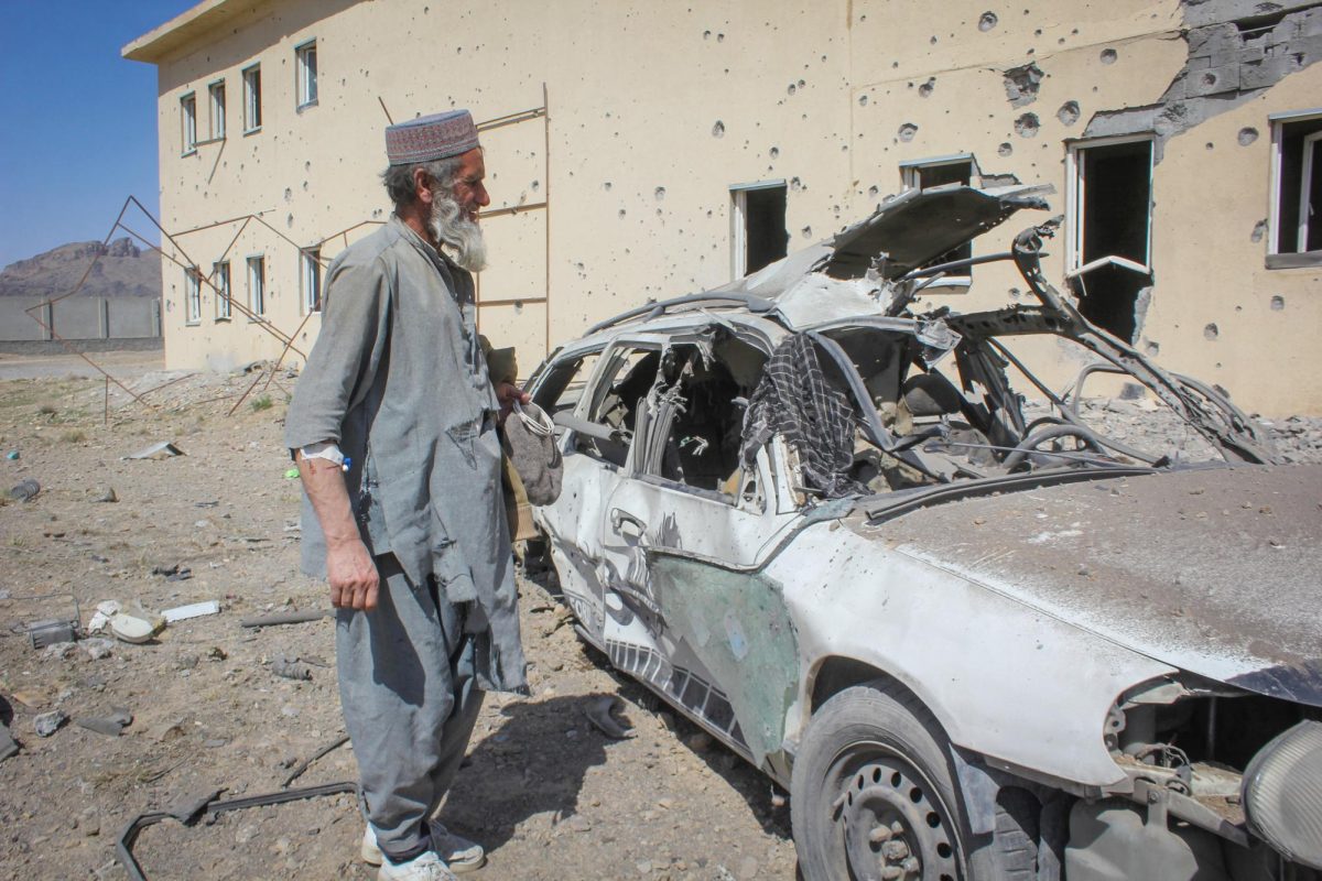 An Afghan man stands next to a damaged car following airstrikes, amid the conflict between Afghanistan and Pakistan, in Kandahar, Afghanistan, February 28, 2026. REUTERS/Stringer